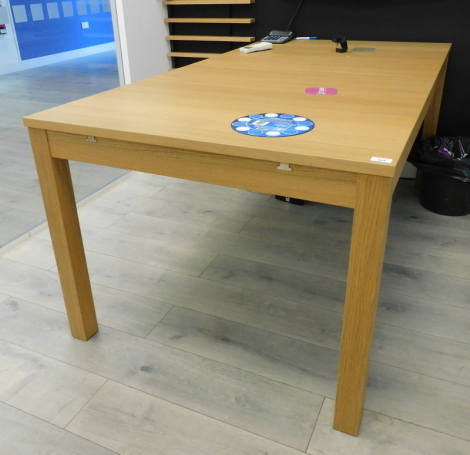 A light oak extending dining or office table. Note: VAT is payable on the hammer price of this lot at 20%. To be sold upon instructions from Grantham Ceilings & Interiors Ltd (in proposed liquidation), viewing and collection is from their premises at Elle