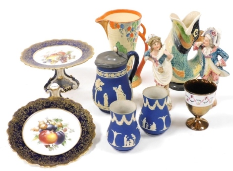 A group of ceramics, to include a Wade Heath pottery Art Deco style jug, decorated with flowers and trees, with orange highlights against a cream ground, 22cm high, a Victorian copper lustre goblet, 12cm high, a fish glug vase, 24cm high, two Paragon pede