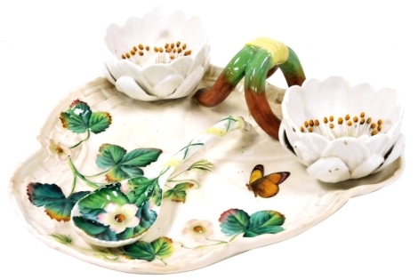 A late 19thC Majolica strawberry set, possibly George Jones, the dish of basket weave trefoil form, moulded with strawberry leaves and painted with a butterfly, with two attached strawberry flower head bowls and a serving spoon, bears registration lozenge