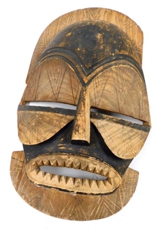 Tribal Art, an African carved wooden wall hanging mask, 64cm high.