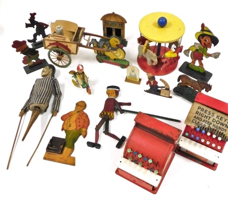 Vintage toys, including two St Michael tin plate imperial tills, Japanese tin plate and celluloid clock work boy on a tricycle, carved wooden Disney figures, Pinocchio, cart pulled by a duck, hand puppet, carrousel, etc.