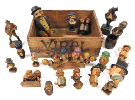 Antique and vintage Black Forest and Swiss carved figures, including nutcrackers and bottle stoppers, in a Virol advertising box.