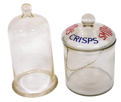 An early 20thC glass jar and cover advertising Smiths Crisps, 27cm high, together with a bell glass cover, 31cm high. (2)