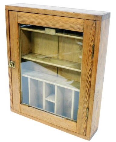 A pine collectors wall mounted cabinet, the glazed door enclosing a fitted interior of shelves and recesses, 54cm high, 45cm wide.