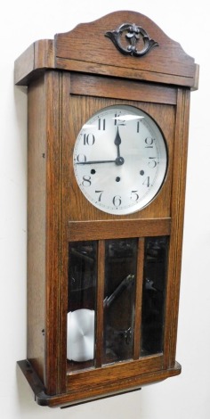 An oak cased wall clock, with Arabic numeral dial, eight day movement with Westminster chime, 80cm high.