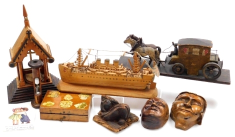 A vintage carved model of a coach and two horses, cruise liner, masks, reliquary, bobbin egg timer and a decoupage box containing paper. (a quantity)