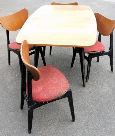 A 1950's G-Plan drop leaf dining table, raised on ebonised outswept legs, 74cm high, 74cm wide, 138cm extended, 83.5cm deep, together with four butterfly single dining chairs. (AF) The upholstery in this lot does not comply with the 1988 (Fire & Fire Fur