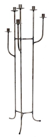 A tubular metal six branch floor mounted candle stand, with splayed legs, 105cm high.