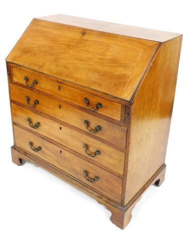 A George III mahogany bureau, the fall enclosing a fitted interior above four graduated drawers, each with brass drop handles, on bracket feet, 107cm high, 99cm wide.