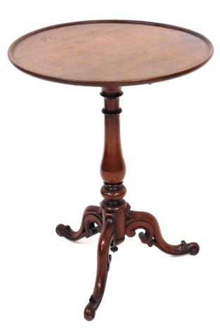 A Victorian mahogany occasional table, the circular dished tilting top on a turned column and scroll carved tripod base, 77cm high, the top 50cm diameter.