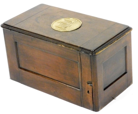 A walnut sewing machine case, the lid applied with a brass roundel embossed with a castle, incomplete, 46cm wide.