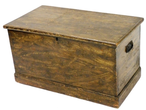 A Victorian scumbled pine blanket box, the hinged lid enclosing a compartment for candles, on a plinth, 50cm high, 69cm wide, 47cm deep.