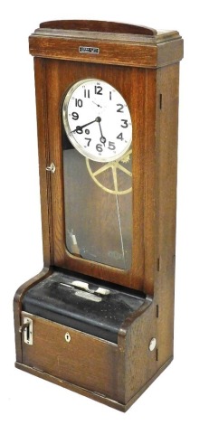 An early 20thC Swiss oak clocking in clock, the white coloured dial with Arabic numerals and with chrome plated fittings, label for JAE GGI and OTT, Zurich, 110cm high, 43cm wide.