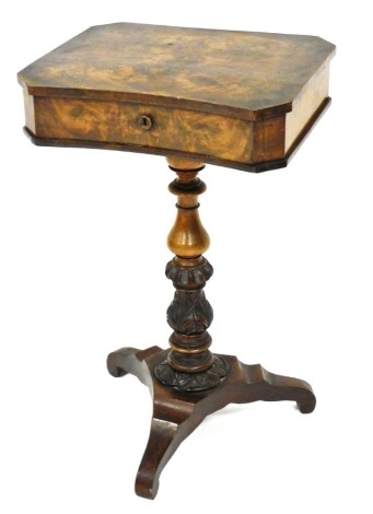 A 19thC walnut sewing table, of rectangular shaped form, the hinged lid enclosing an arrangement of compartments, on a turned leaf carved column terminating in tripod base, 76cm high, 48cm wide, 39cm deep.