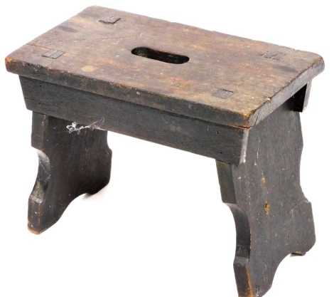 A stained elm footstool, of rectangular form, on shaped supports, 33cm high, 45cm wide.