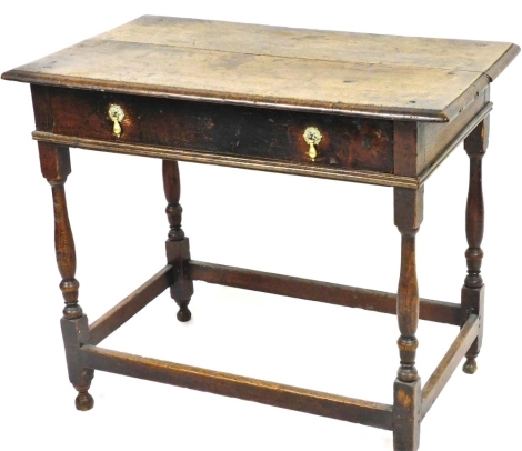 A late 17th/early 18thC oak side table, the rectangular top with a moulded edge above a frieze drawer, on turned supports with bun feet, 74cm high, 87cm wide, 50cm deep.