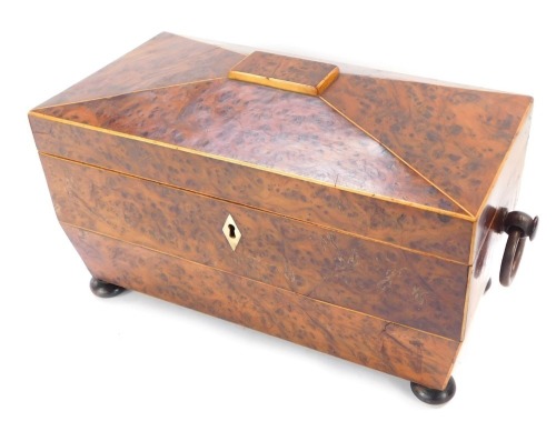 A Victorian burr walnut tea caddy, with a domed top, and mother of pearl keyhole, with swing handles, on bun feet, 19cm high, 31cm wide, 16cm deep.