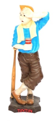 A plastic Tintin advertising model, depicting Tintin frowning and leaning on a baseball bat, on stepped base, painted plastic, 87cm high.