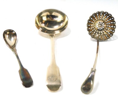 Three Georgian and later spoons, comprising a Georgian toddy ladle, hallmarks rubbed, a Victorian serving ladle, Fiddle pattern, bearing the initials CLK, 3½oz, and a silver plated sifter spoon. (3)