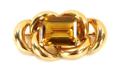 A citrine bar brooch, set with rectangular cut citrine, with border of interlinked scrolls, on single pin back, yellow metal, unmarked, believed to be 9ct gold, 4.5cm wide, 12g all in.