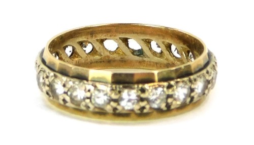 An eternity ring, set with CZ in a hammered outer border, yellow metal stamped 9ct, size P½, 3.6g all in.