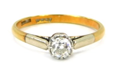 An 18ct gold and platinum diamond solitaire ring, with old cut diamond in illusion platinum setting, approx 0.15ct, with platinum shoulders on a yellow metal band, size M, 2g all in.