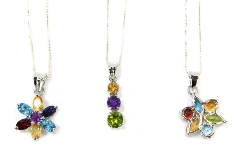 Three silver multi stone set necklaces, comprising two cluster pendants formed as flowers, and a three drop pendant, each on box link white metal chain, stamped 925, 44cm long, 15g all in. (3)