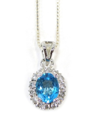 A silver blue zircon and CZ set cluster pendant, the basket setting with oval blue zircon surrounded by CZ stones on a white metal box link neck chain, stamped 925, 44cm long, 5.9g all in.