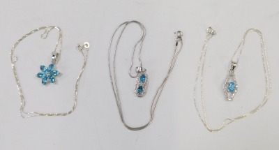 Three blue zircon and silver pendants and chains, comprising a six point cluster pendant, an Art Deco style two blue zircon set pendant and a further example, one on articulated chain, the others on fine link chains, 44cm long, 13.3g all in. (3) - 2