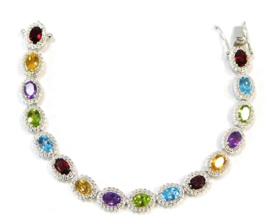 A multi stone set bracelet, each link formed as a cluster, with multi coloured stones to include purple, green, blue, red, and yellow, white metal stamped 925 to clasp, 25.9g all in, 19cm long.