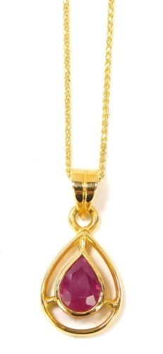 A ruby pendant and chain, the tear drop shaped pendant set with central faceted stone, on a fine link neck chain, yellow metal stamped 750, 44cm long, 3.9g all in, boxed.