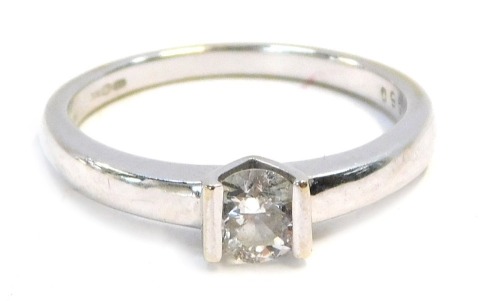 An 18ct white gold diamond solitaire ring, with round brilliant cut tension set stone, measuring approx 0.50cts, size Q½, .6g all in.