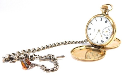 A Waltham USA gold plated hunter pocket watch, with white enamel dial and seconds dial with bezel wind, on a silver curb link watch chain, with swivel imitation amber fob.