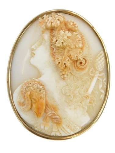 A 19thC shell cameo brooch, with raised maiden in flowing robes and headdress, in a yellow metal frame, unmarked, 4.5cm x 5cm.