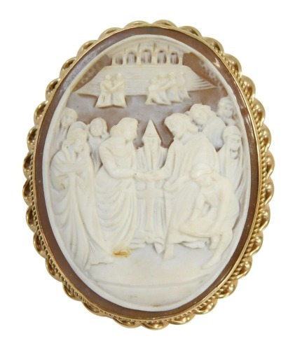 An early 20thC shell cameo brooch, with heavily carved relief religious scene, with buildings in the foreground, in a yellow metal frame with rope twist and beaded border with single pin back, yellow metal, unmarked, 4.5cm, 14.6g all in.