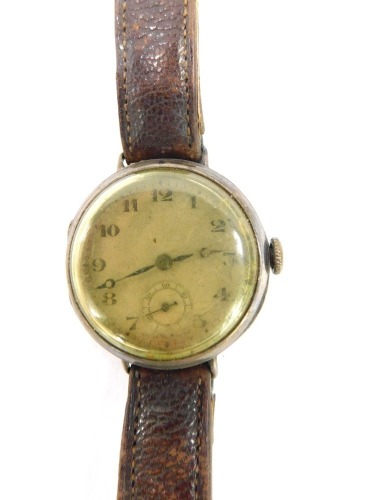 A 1930's silver gentleman's wristwatch, with a silvered colour numeric dial with seconds dial and blue hands, on a brown leather strap, 31.2g all in.