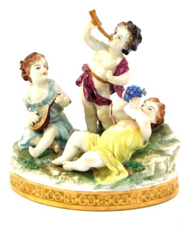 A porcelain figure group, formed as three children playing musical instruments, on a naturalistic base, polychrome decorated in green, yellow and pink, the raised moulded base marked GB Foreign, 17cm wide.