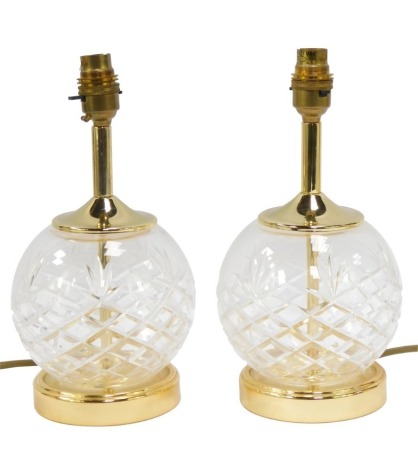 A pair of cut glass table lamps, each with gilt metal mounts and floral shades, 26cm high.