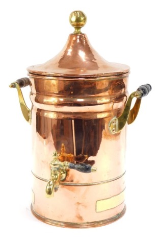 An early 20thC copper tea urn, with domed lid, brass orb top and front tap, with further brass mounts and turned ebonised handles, 39cm high.