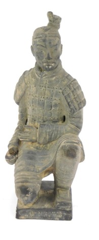 A terracotta style Chinese grave figure, kneeling in flowing robes, on a shaped base, 22cm high.