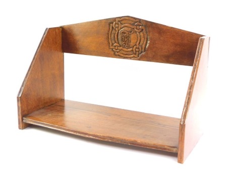 A 20thC oak book trough, with initialled rosette back and plain border base, 15cm high.