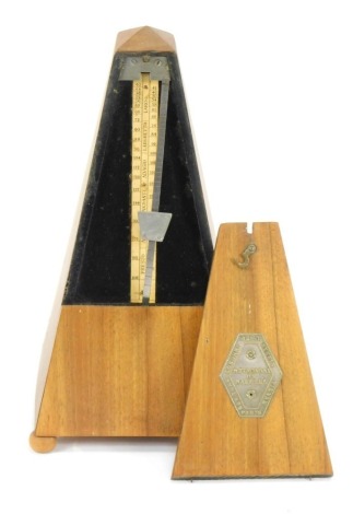 A metronome, stamped Maelzel, on bun feet, 22cm high.