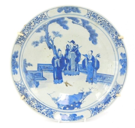 A 19thC Japanese blue and white charger, with Chinese figures with a floral border, 34cm diameter. (AF)