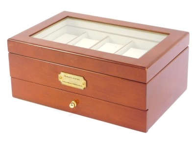 A watch display case, in a walnut finish with inserts for ten wristwatches and a pull out drawer, with applied plaque, 12cm high, 30cm wide, 20cm deep.