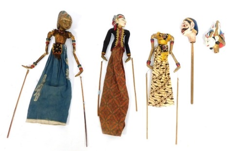 A group of Eastern hardwood puppets, each of varying design with heavy gilt painted detail, some with strings. (a quantity)