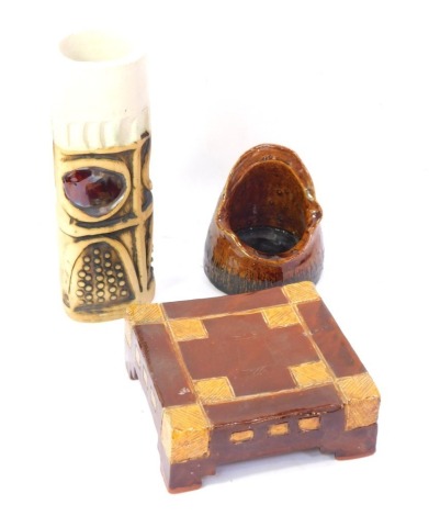 A Bob Dawe studio pottery cylindrical vase, 22cm high, a studio pottery ashtray or candle holder by Pauline Drake, and a studio pottery stand. (3)