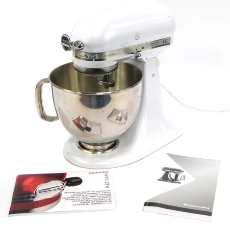 A Kitchen Aid Artisan stand mixer, in white lustre, with instruction book and mixing bowl, 36cm high.