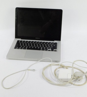 An Apple Mac Book Pro, with charger cable. - 3