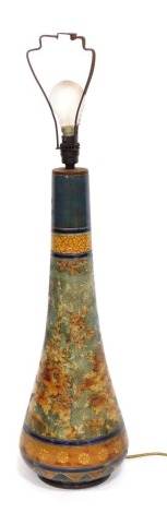 A Doulton Lambeth Slater's patent tapering vase, with a turquoise neck, on a dark blue floral gilt scaled body and lappet bordered base, impressed marks, 82cm high. NB. Illustrated with a drop in electrical lamp conversion. There is a single drill hole to