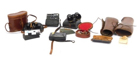 A group of camera and optics equipment, comprising a pair of opera glasses (AF), a Whitman, a set of Royal 8x30 binoculars, two leather archery sleeves. (a quantity)